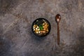 Japanese miso soup with tofu and salmon in a black bowl on a vintage colored background with a wooden spoon. Top view Royalty Free Stock Photo
