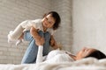 Japanese Mom Riding Baby On Legs Playing At Home Royalty Free Stock Photo