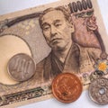 Japanese money, notes and coins, lie on a white paper background. 10000 yen banknote close-up. Aged effect shot. Financial Royalty Free Stock Photo