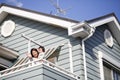 Japanese mother and child waving hands on the veranda at home