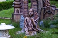 Japanese mythology concept. Front view of a traditional woman statue holding handfan in meditative posture