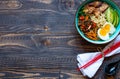 Japanese noodles bowl with chicken, carrots, avocado