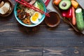 Japanese noodles bowl with chicken, carrots, avocado