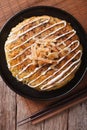 Japanese okonomiyaki on a table close-up. vertical top view Royalty Free Stock Photo