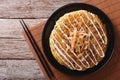 Japanese okonomiyaki on a wooden table. Horizontal top view Royalty Free Stock Photo