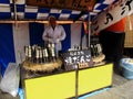 Japanese old men vendor chef cooking and sale snack dango or japanese dumpling sweet made from mochiko at street market festival