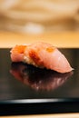 Japanese Omakase in Edo Style: Close up Otoro Fatty Tuna Sushi served on glossy black plate. Japanese traditional luxury meal Royalty Free Stock Photo