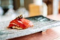 Japanese Omakase meal: Aging Raw Akami Tuna Sushi adds with sliced truffle served by hand on a stone plate. Royalty Free Stock Photo