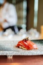 Japanese Omakase meal: Aging Raw Akami Tuna Sushi adds with sliced truffle served by hand on a stone plate. Royalty Free Stock Photo