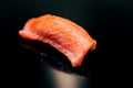 Japanese Omakase meal: Close up Chutoro Bluefin Tuna Sushi served by hand with pickled ginger on glossy black plate. Royalty Free Stock Photo