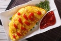 Japanese omelet stuffed with rice closeup. Horizontal top view Royalty Free Stock Photo