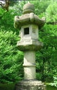 Japanese outdoor stone lantern and lake in zen garden