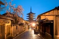 Japanese pagoda and old house with cherry blossom in Kyoto at twilight. Royalty Free Stock Photo