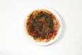 Japanese pancake called okonomiyaki on a plate isolated on a white background