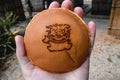 Japanese pancake snack with a symbol of mythical Okinawa dog Shisa