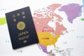 Japanese passport front cover on a map on North America on the background