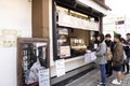 Japanese people and foreign traveler stand waiting line up for buy Dango or Japanese dumpling and sweet made from mochiko Royalty Free Stock Photo