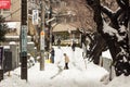 Japanese people removing snow with a shovel