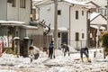 Japanese people removing snow with a shovel