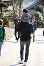 Japanese people son ride on the neck of father walking visit and praying in Naritasan Shinshoji Temple at Chiba in Tokyo, Japan