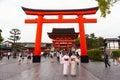 Japanese people and tourists enter Fushimi Inari Shrine