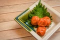 japanese pickled plum with shiso leaf on wooden background