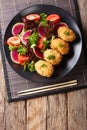 Japanese potato korokke and fresh vegetables close-up. Vertical