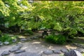 Japanese private garden with stone lantern and path laid with stones Royalty Free Stock Photo