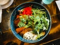 Japanese ramen with spoiled egg and fried pork and vegetables bowl inside restaurant