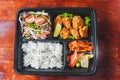 Japanese ready-made lunchbox, Bento with Hinomaru style rice and deep fried chicken on wood background