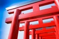 Japanese red wooden poles with blue sky.Walkway with red wooden poles Japanese style