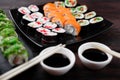 Sushi rolls on plate with sauce and chopsticks Royalty Free Stock Photo