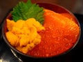 Japanese rice bowl topped with fresh salmon, salmon eggs and sea urchin sashimi salmon and roe, uni