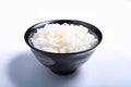 Japanese rice cooked in a black bowl on a white background Royalty Free Stock Photo