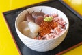 Japanese rice topped with hotate, snow crab, salmon sashimi, and salmon roe