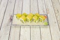 Japanese rice uramaki sushi stuffed with avocado, mango, surimi, nori seaweed and avocado slices covering the roll Royalty Free Stock Photo