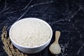 Japanese rice in white ceramic bowl and wooden spoon on dark marble table Royalty Free Stock Photo