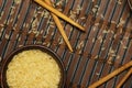 Japanese rice in a wooden bowl. Wooden chopsticks On the table of a bamboo mat. Asian cuisine. View from above. Royalty Free Stock Photo