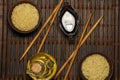 Japanese rice in a wooden bowl. Wooden chopsticks On the table of a bamboo mat. Asian cuisine. View from above. Royalty Free Stock Photo