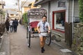 Japanese rickshaw driver in an alley in Kyoto, Japan