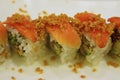 Japanese roll uramaki style with rice outside and seaweed nori inside sharp focus on the raw salmon
