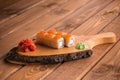 Japanese rolls Philadelphia with salmon caviar on a wood board Royalty Free Stock Photo
