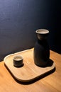 Japanese sake in ceramic jug and black cup on wooden plate Royalty Free Stock Photo