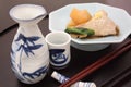 Japanese Sake with simmered Japanese amberjack and white radish Royalty Free Stock Photo