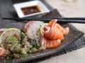 Japanese sashimi on a black dish