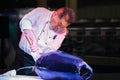 Japanese `Sashimi` chef preparing a fresh Maguro