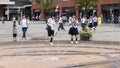 Japanese Schoolgirls have fun on the square near the fountain Royalty Free Stock Photo