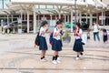 Japanese Schoolgirls have fun on the square near the fountain