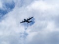 Japanese self defense force C-130 airplane flying above Naval Air Facility Atsugi before landing