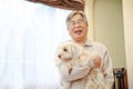 Japanese senior man holding pet dog